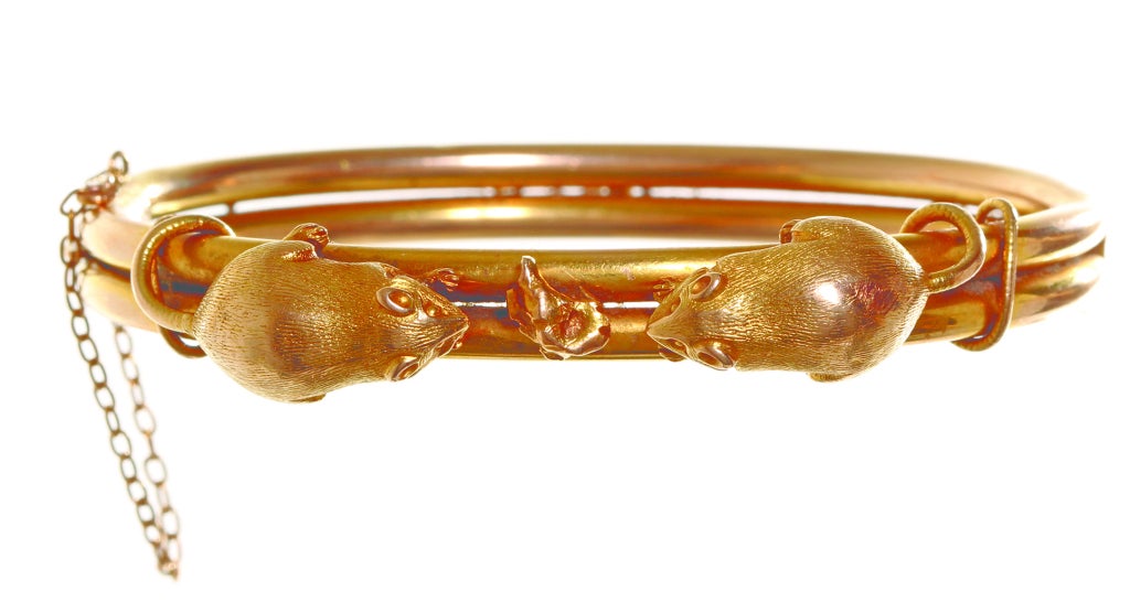 Amusing English mouse bangle circa 1880's in 15k gold. These unlikely subjects for jewelry were offered as lucky charms. A copy of an advertisement from July of 1880 featuring Thornhill's mouse jewellery can be seen in 