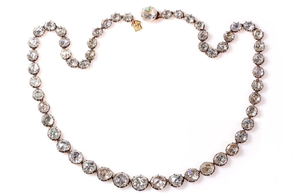 Exceptional 18th century rose cut diamond rivière necklace. Each rose cut diamond is set in silver on gold cut away settings with 54 bright foiled diamonds that are delicately graduated in size. The largest stone measures approximately 8.00 mm in