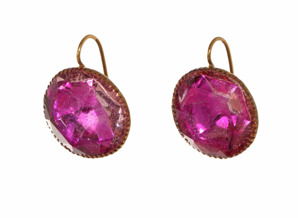 18th Century Queen Anne pink paste earrings. These would have been part of a larger piece of jewelry and converted into earrings in more modern times. On Gold wires the stones are set in brass.  English in origin, found in London. Circa 1740-80.