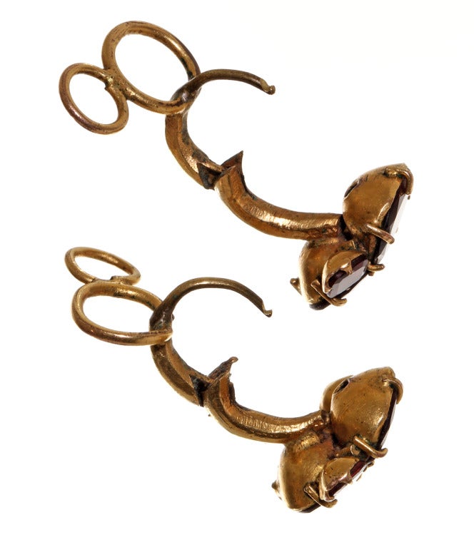 English Queen Anne garnet earrings in pinchbeck metal. Circa 1720 -1740.

A very rare find,  300 year old Queen Anne style earrings.  Wearable, original hooks with double 'wig hooks' intact. These hooks served a double purpose, on larger earrings