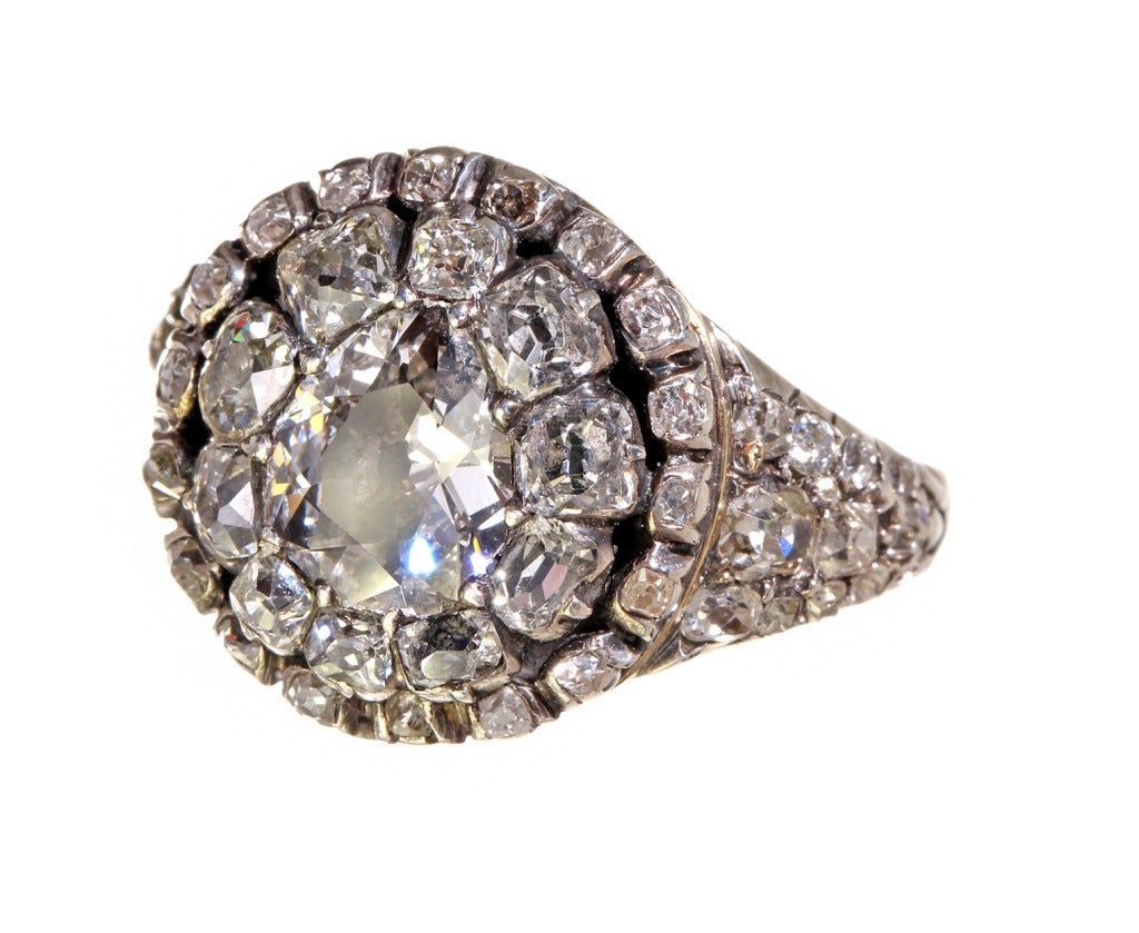 Amazing early ring. Bright mine cut diamonds set in a double halo pattern surrounding a central pear cut stone. The shoulders of the ring are encrusted with pavé set stones. All foil backed stones are still bright and set in Sterling Silver on 18k