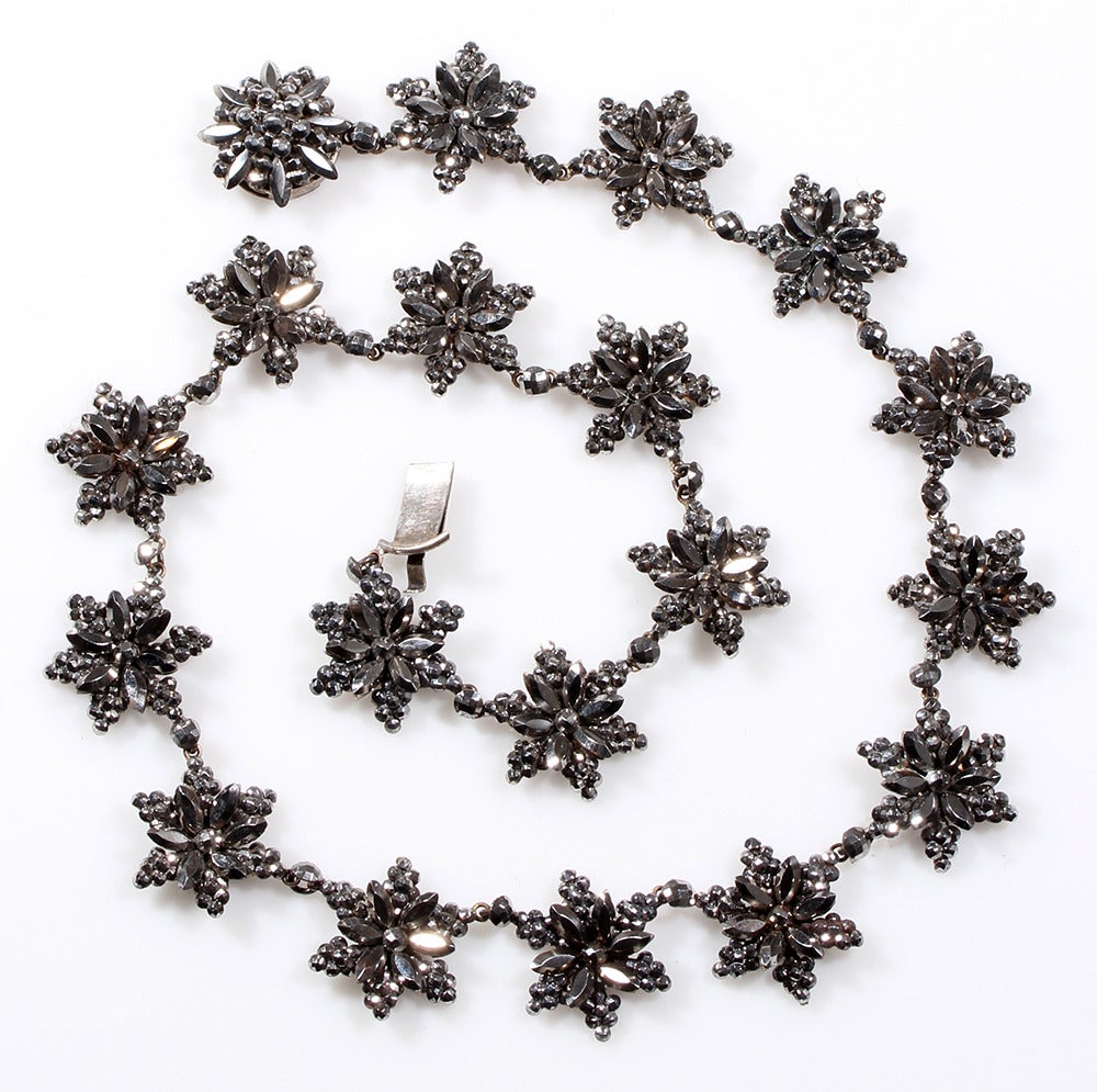 Early 19th Century Cut steel necklace. Beautifully preserved with a bright gray sparkle. Most likely English in Origin. 

Steel Jewelry was introduced in the mid 1700's. Its popularity was spurred by the French Revolution. Used as an effective