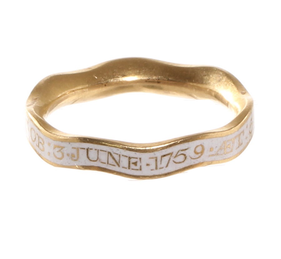 Beautifully preserved mourning ring made in 1759.  English in origin in 18k gold. The ring is in a more rarely seen white enamel indicating the person was unmarried. Also in an unusual wavy hoop form. Reads: 