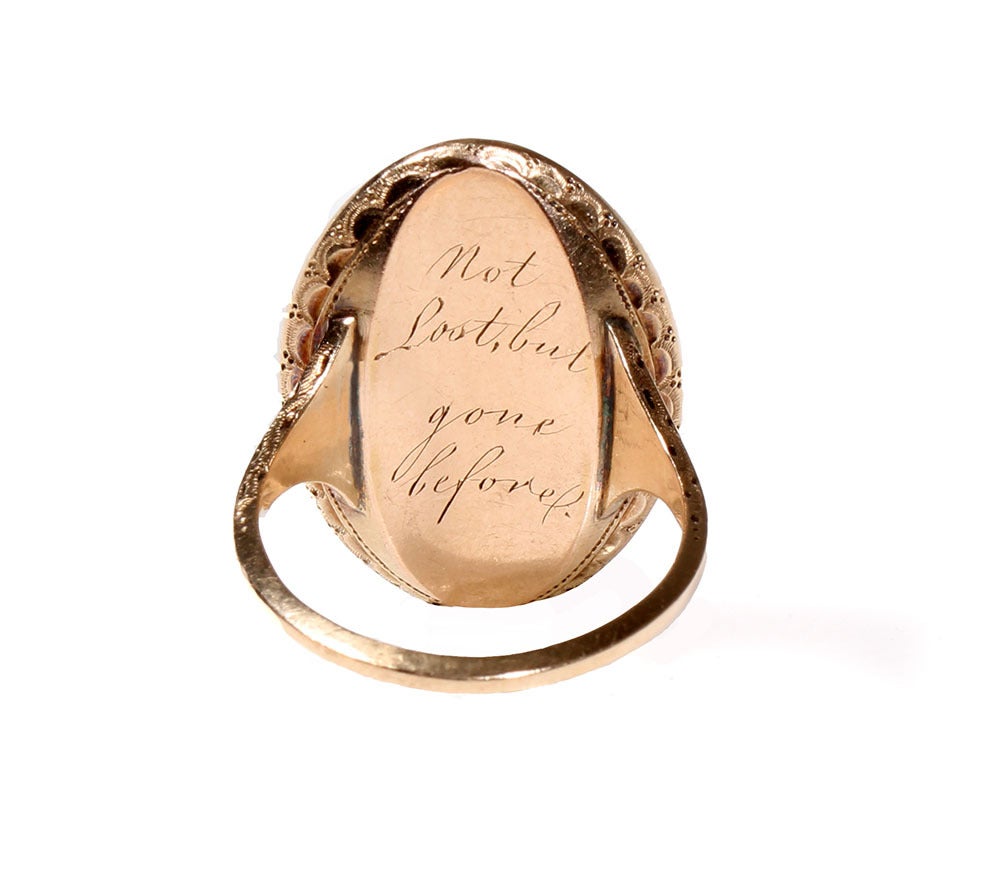 Beautifully preserved Georgian era mourning ring. Unlike most rings of this sort, the urn is formed out of gold and laid on to a ground of dark fabric. More common versions feature plaited hair.  The crystal is in bright clean condition. The hand