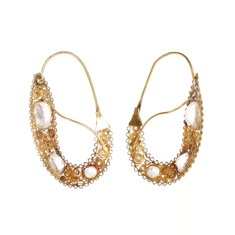 Neoclassical in design, earrings such as these are referred to as poissardes. They consist of an elongated oval form with delicate gold work surrounding pink paste stones.  The gold work is typical of the late Georgian period. Original S shaped