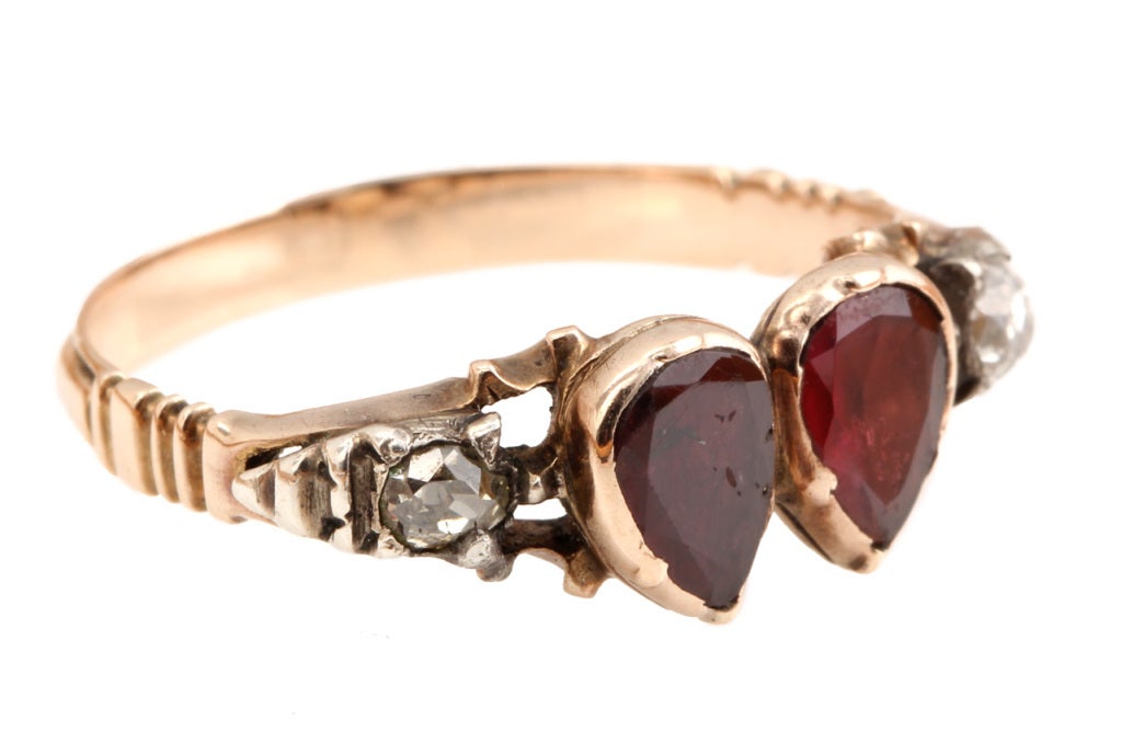 Garnet double heart ring set in 10k gold.
Size 6.5, can be sized. Pictured on model with our Georgian Garnet Closed Back Ring and Georgian Garnet & Paste Ring. See bellandbird.com for details.

Please see bellandbird.com for more of our rings.