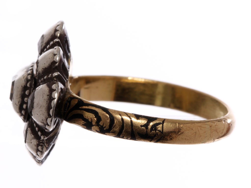 Center table cut diamond with rose cut diamonds surround. Silver topped gold with counter enameling and enameled shank. Current ring size is an 8. It can be sized.

Please see bellandbird.com for more of our rings.