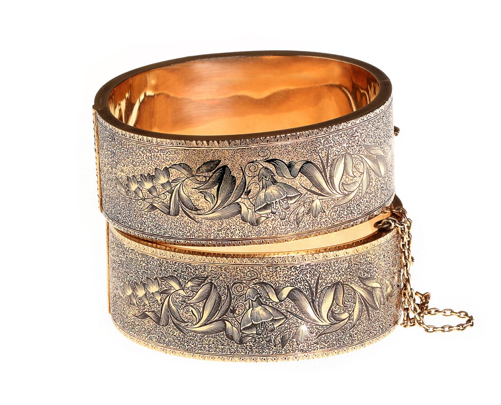 Wonderful & rare matched set of Victorian era gold bangles. Beautifully intricate taille d'epargné enamel details on both sides.    Floral symbolism makes for a perfect sentiment for a set of wedding bracelets. Bangles such as these were typically