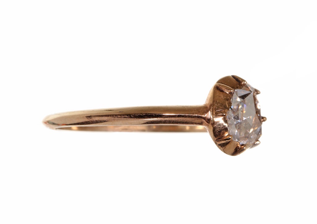 Beautiful 18th century rose cut diamond solitaire ring. The brightly foiled diamond is set in a closed back, cut-away setting. 18k gold. Approximate size 5, can be sized. Shown on model with our antique diamond band sold in-store.