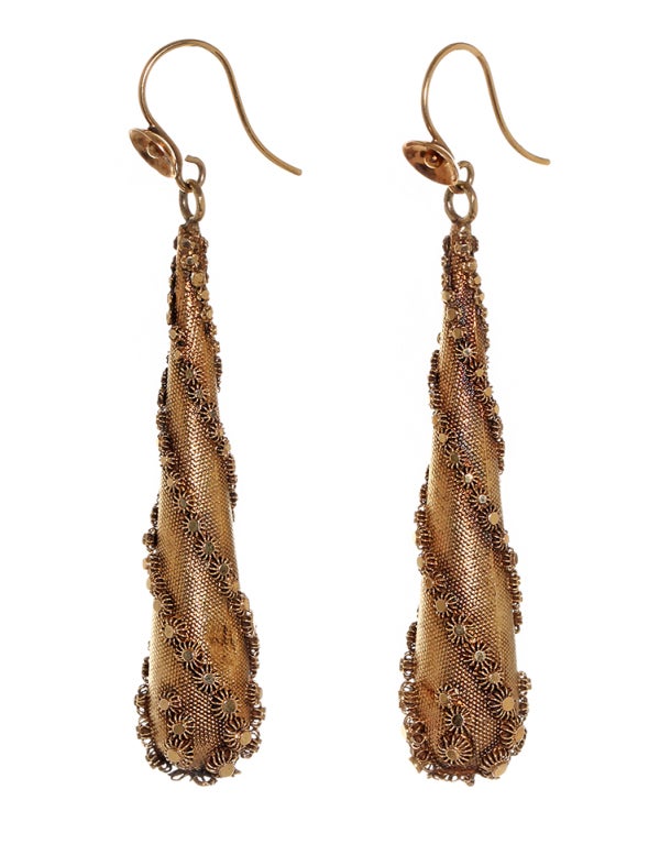 Wonderful example of torpedo drop earrings from the 1830's & 1840's. Their size and lightness were dictated by fashion and economic factors. The horizontal lines of style of dress and hair needed to be offset by long pendants. While at the same time