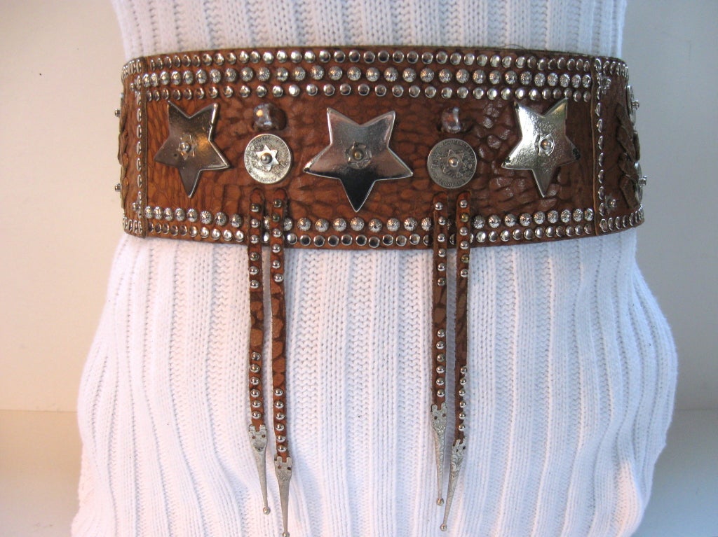 This most unusual and decorative belt was purchased from Henry Lehr in 1984.  It is comprised of embossed leather in a rich brown color, and measures  2 7/8