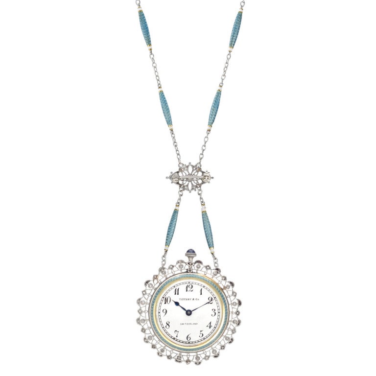 Belle Epoque pendant watch with chain, with an ivory-colored dial and painted black Arabic numerals, in an elegant guilloche light blue enamel platinum case with rose-cut diamond-set and hand-engraved melee fringe, mounted in platinum, the case with