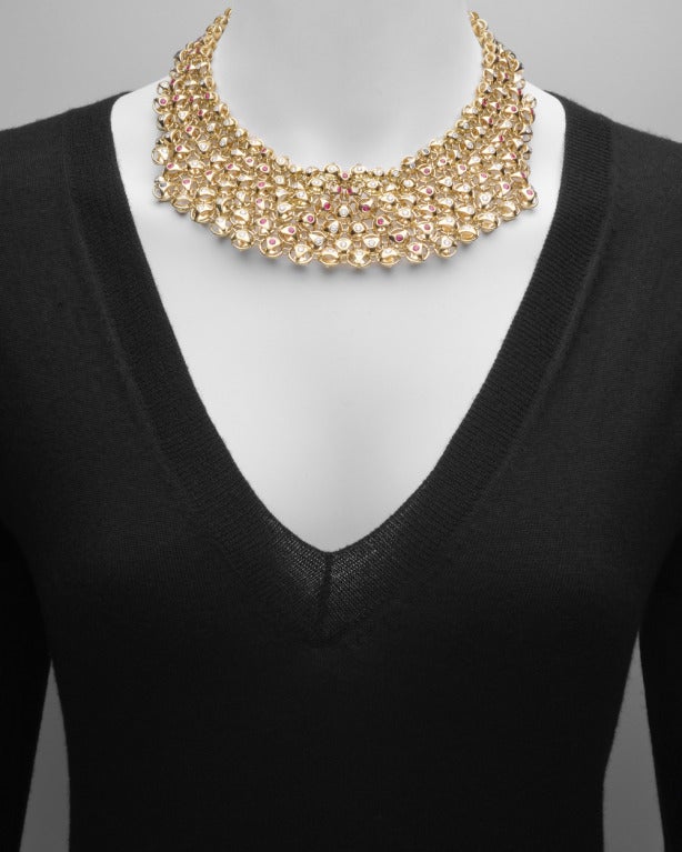 Gem-set bib necklace, designed as a flexible collar of ball-shaped links, graduating from six rows in front to three rows in back, each link set with a circular-cut diamond or ruby, the diamonds weighing approximately 5.00 total carats, mounted in