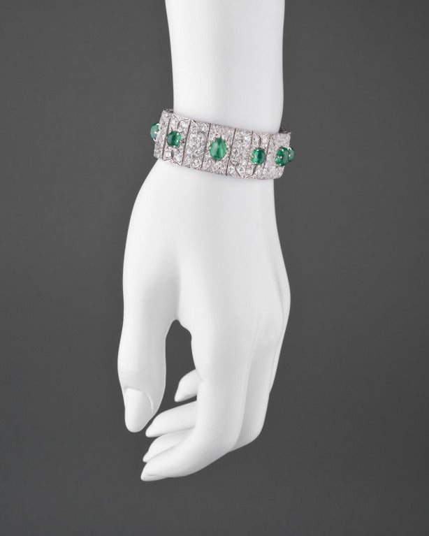 Emerald and diamond Deco-style bracelet, with seven cabochon-cut oval-shaped emeralds weighing approximately 5.00 total carats and circular-cut diamonds weighing approximately 18.89 total carats, mounted in platinum, signed J.E. Caldwell & Co. 7.25