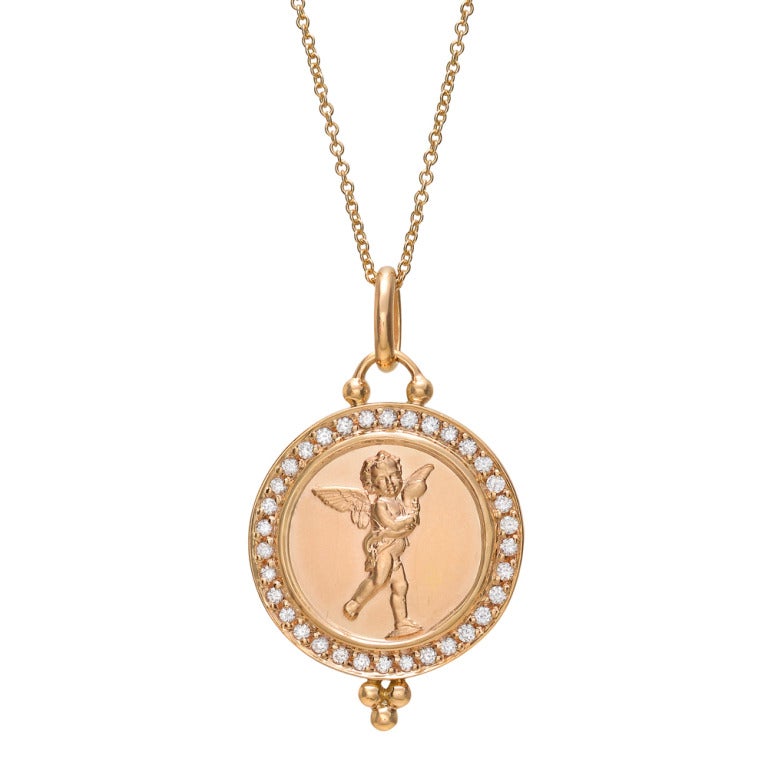 Circular-shaped pendant, depicting a cherub holding a dolphin, with pavé diamond frame and adorned with Temple St. Clair's signature granulation at the bottom. Diamonds weighing approximately 0.34 total carats. Designed by Temple St. Clair. 16mm