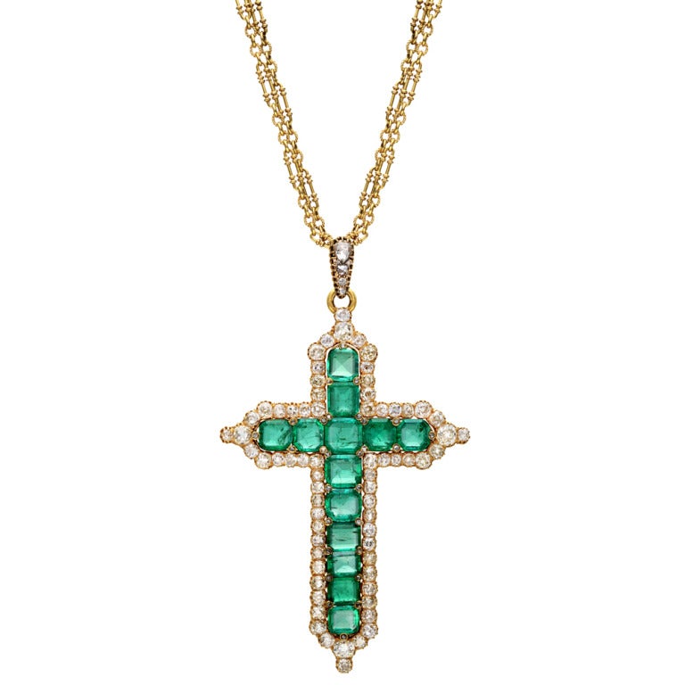 Turn-of-the century emerald, and diamond pectoral cross, lavishly set with 13 fine Colombian emeralds surrounded by 68 old mine-cut diamonds, the interstices between the emeralds set with 28 rose-cut diamonds, hanging from a bale set with 4 rose-cut