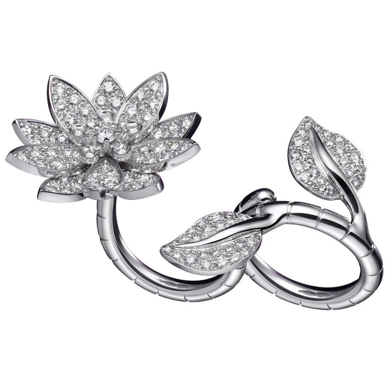 Lotus between-the-finger ring, accented by round brilliant cut diamonds weighing approximately 2.30 total carats, mounted in 18k white gold, signed 