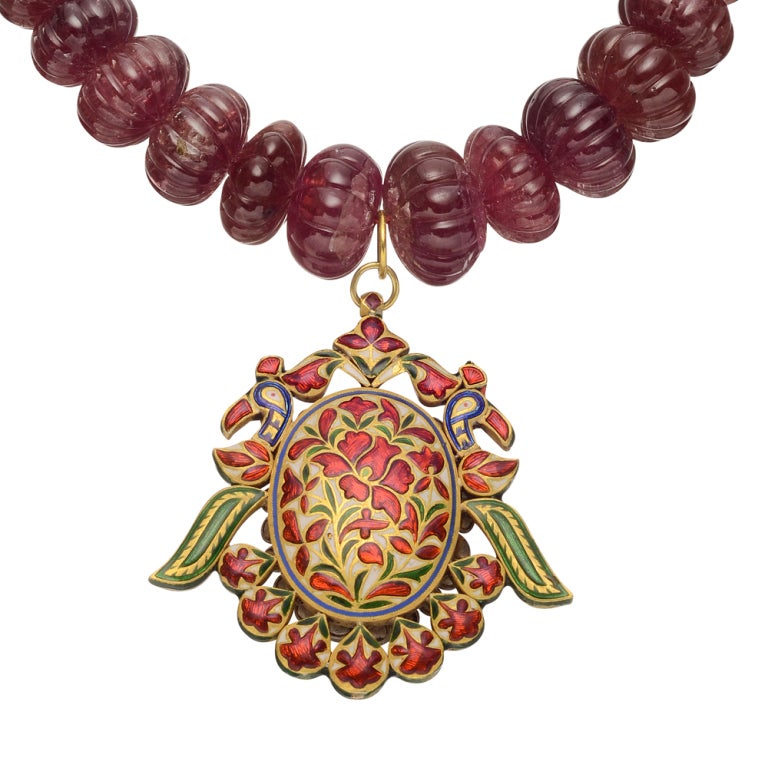 Ruby bead necklace with gem-set pendant, designed as a graduated strand of fluted ruby beads with an 18k yellow gold 