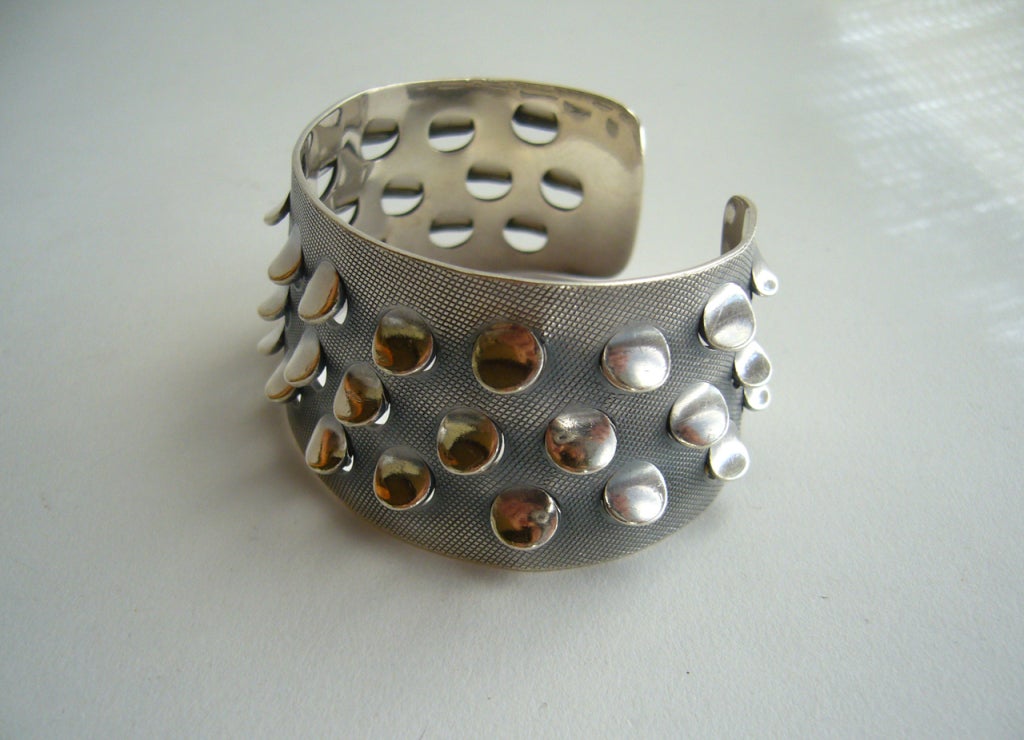 A sterling silver bracelet with punched out 'scales' created by Norwegian designer, enamelist and jeweler Grete Prytz Kittelsen.  Bracelet measures 1 1/2