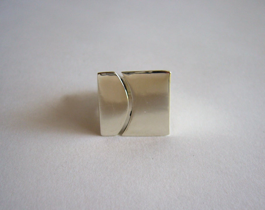 Sterling silver ring featuring a pierced curve design made by José Maria Puig Doria of Barcelona, Spain. Ring is a finger size 6 3/4 and is quite heavy, weighing 24.3 grams.  Signed Puig Doria, 925.    

In excellent vintage condition.