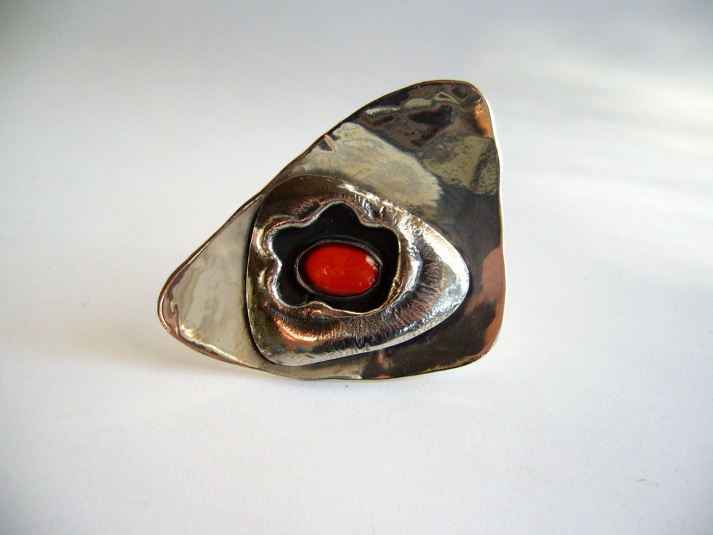 A large sterling silver and carnelian handmade brooch designed by Ed Wiener.  Brooch features an offset carnelian cabochon in an organic pod like setting.  Brooch measures 3 1/4