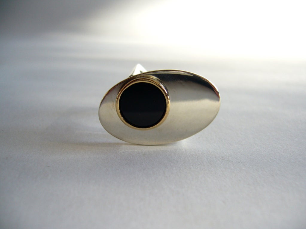 An incredible 1970's ring mad by Pierre Cardin of France.  Sterling ring features a flat faced onyx surrounded by a 14k gold bezel.  Face of the ring is large, measuring 1 1/4