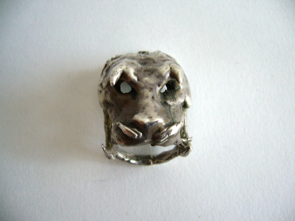 Un anillo de plata de ley hecho a mano, único en su especie, con una cabeza de jabalí demoníaca, creado por el cubano Ernesto Gonzalez Jerez.   Ernesto llegó a Estados Unidos en 1947 y rápidamente se dio a conocer por su método de bronce goteado con