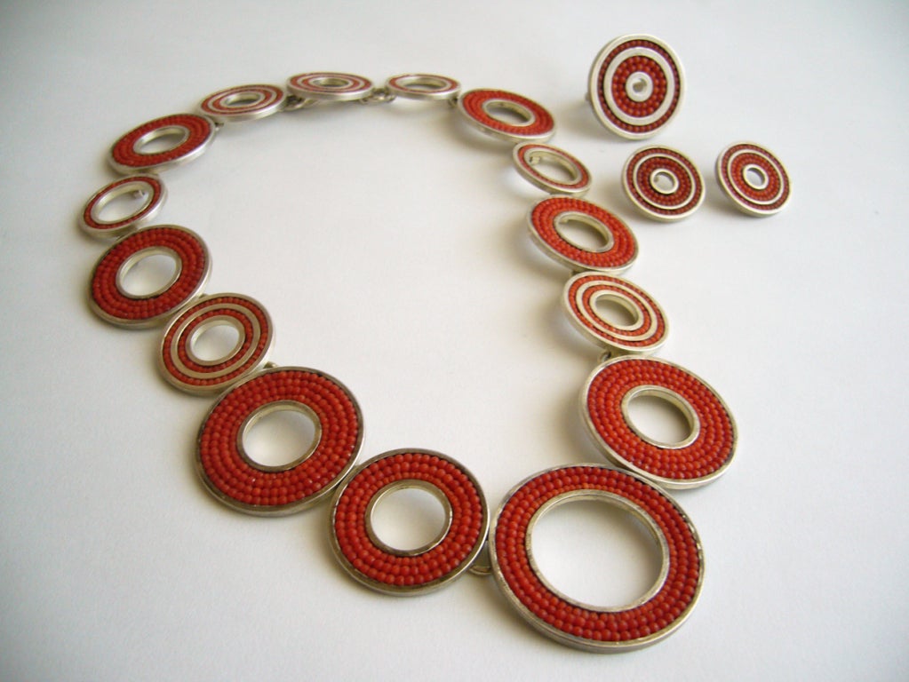 A 1970's sterling necklace, ring and earring set with inlaid coral beads.  Necklace measures 19