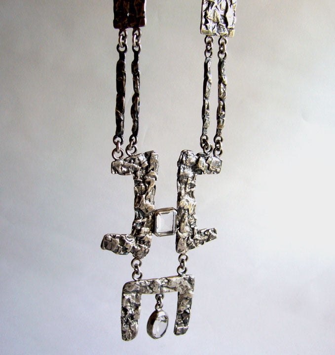 A textured sterling silver and rock crystal necklace created by Rachel Gera.  Pendant measures 4 1/2 long by 3