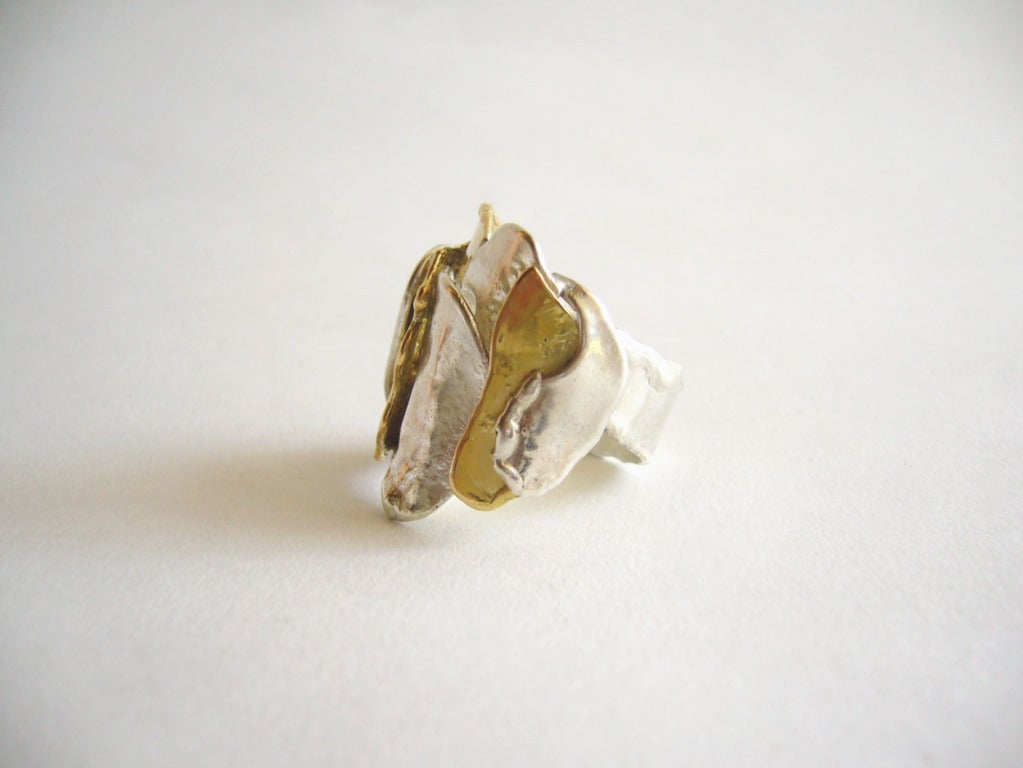 A custom made 18k gold and silver ring from Europe.  Ring features layers of metals with a ripped edge effect.  Ring is a finger size 8 1/2 and signed 800 with an illegible hallmark.  In excellent vintage condition.