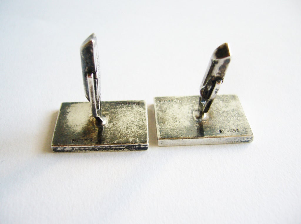 Sterling silver cufflinks made by Laguna Beach California jeweler, Everett Macdonald.  Cufflinks feature a stylized fish design, popular in the 1950's.  They measure  and are signed Macdonald, Sterling.  In excellent condition.