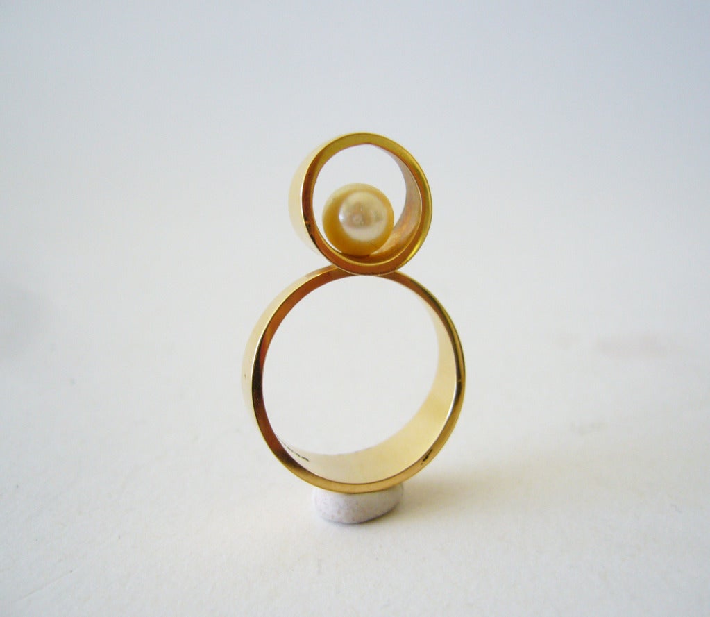 A 14k gold and pearl modernist ring designed by Just Andersen of Denmark.  Ring is a finger size 6 1/2 and is signed JA, Denmark, 585.  In excellent vintage condition.