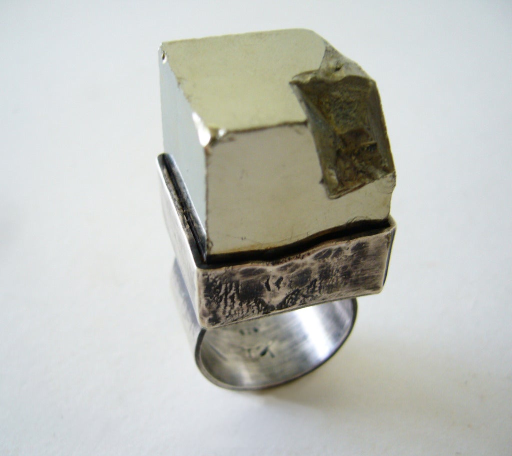 A sterling silver ring featuring a mirrored cube of pyrite designed and created by Heidi Abrahamson of Phoenix, Arizona. Ring sits 1