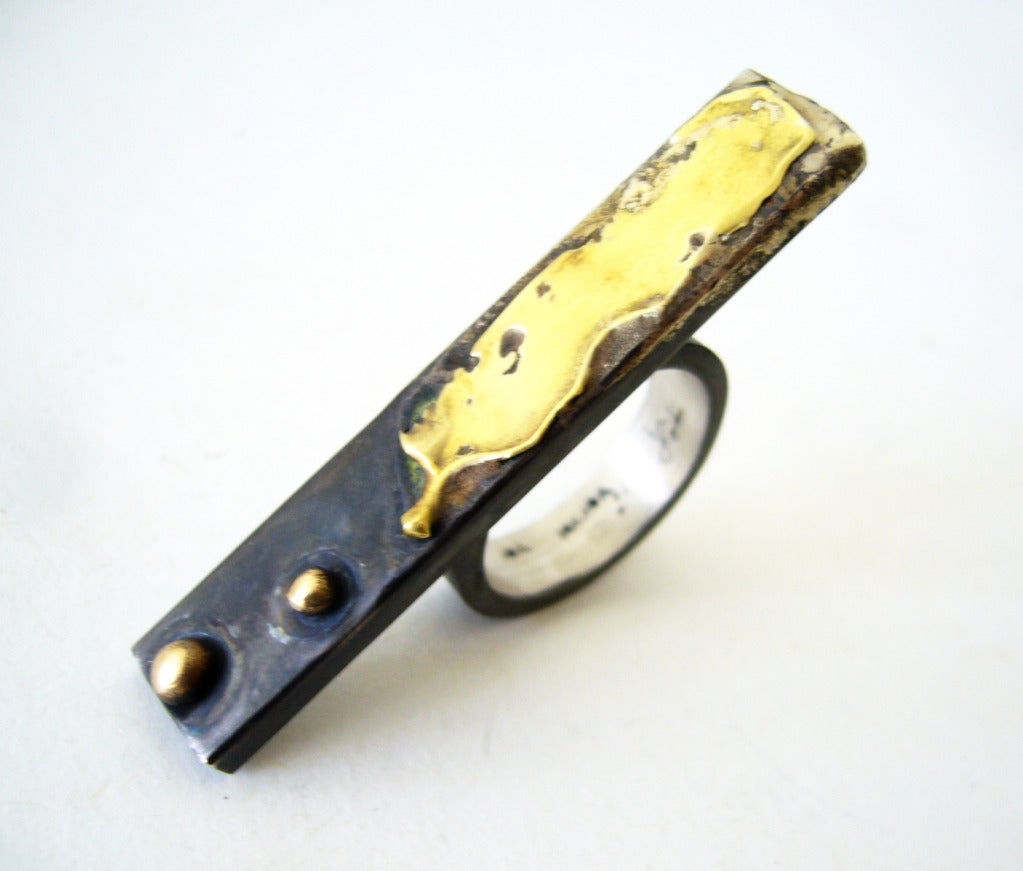An oxidized sterling silver and gold flat bar ring designed and created by Heidi Abrahamson of Phoenix, Arizona.  Ring features an abstract swipe of 18k gold, along with 14k gold balls using the granulation technique.  A finger size 8 and signed