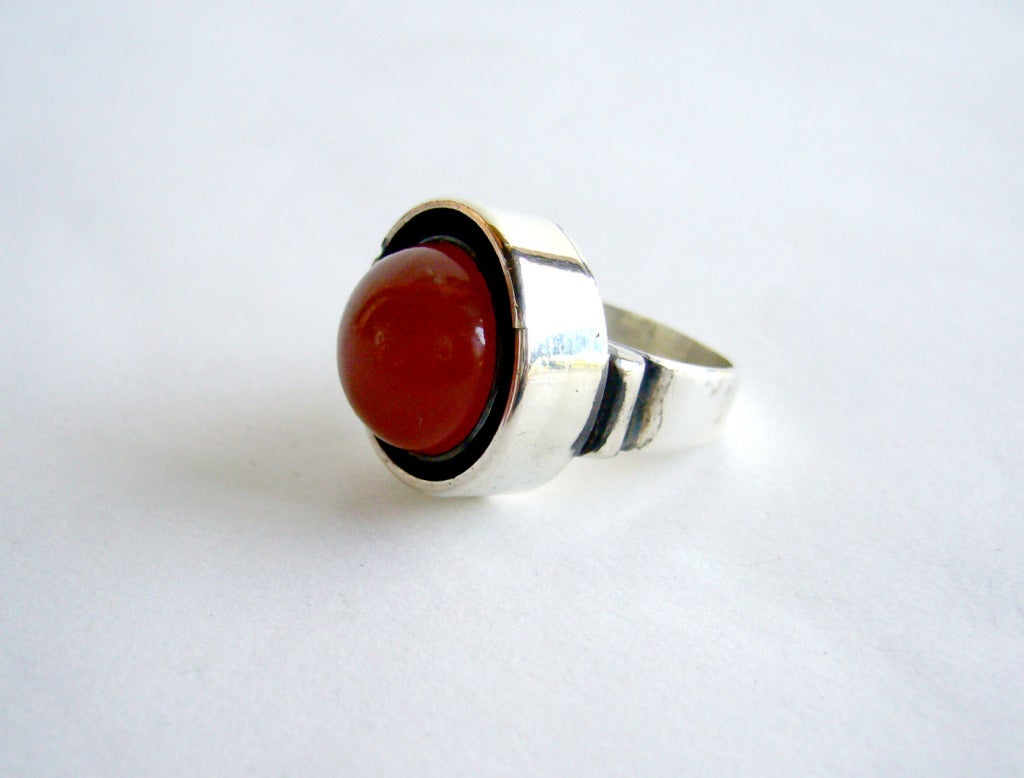 Sterling silver and high domed carnelian ring created by Philip Paval.  Ring is a finger size 5 3/4 to 6.  In excellent vintage condition.

As a teenager, Paval was apprenticed to a silversmith and studied art in Denmark. After immigrating to
