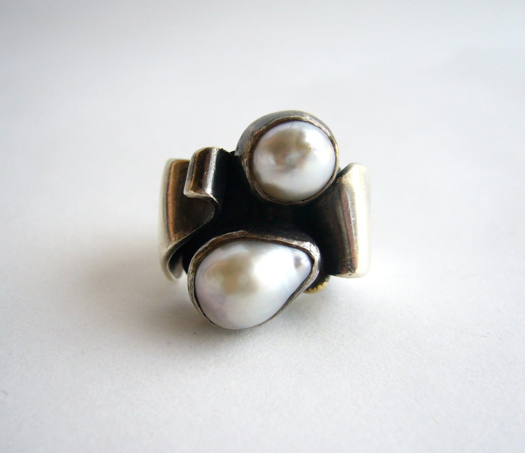 Sterling silver and mabé pearl one of a kind ring by jeweler Philip Paval of Los Angeles.  Ring features a bead of gold tucked within the folds of sterling silver.  A finger size 3.75 - 4 and in excellent vintage condition.

As a teenager, Paval
