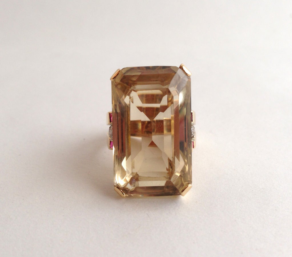 A large, faceted emerald cut Citrine, Ruby and Diamond ring set in a retro 14k Gold setting.  Ring is a finger size 8 and in very good vintage condition.