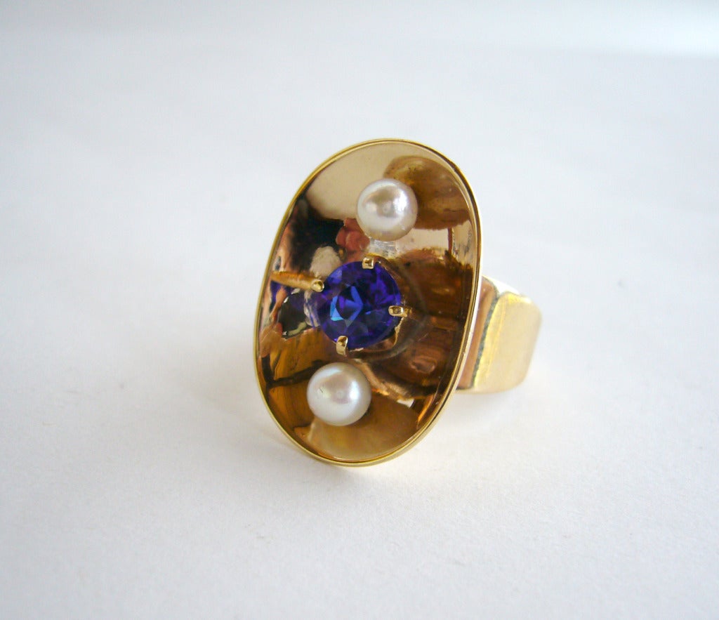 A 14k gold ring set with pearls and blue sapphire created by Philip Paval of Los Angeles. Ring is a finger size 8 and is signed Paval 14k. In excellent vintage condition.

As a teenager, Paval was apprenticed to a silversmith and studied art in