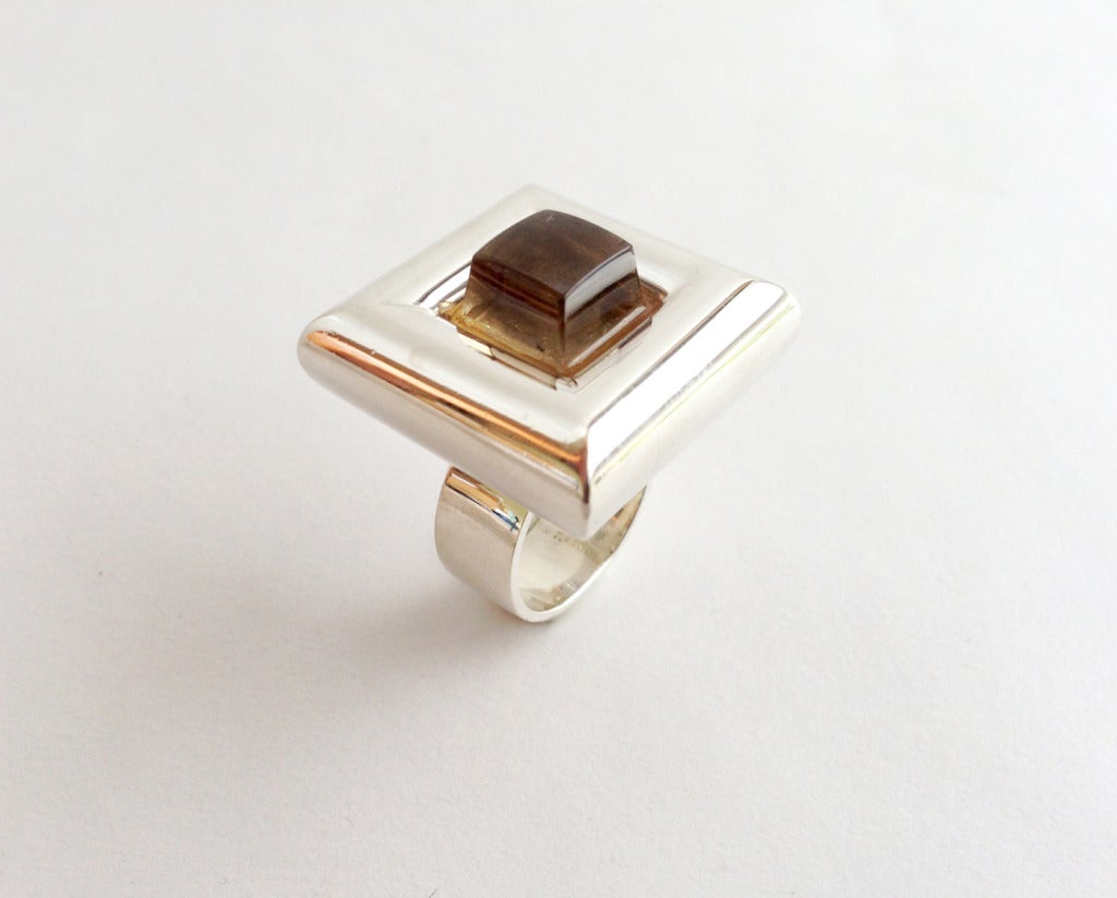 A rare, Danish modernist sterling silver and topaz ring designed by Bent Gabrielsen Petersen for the Hans Hansen Silversmithy circa 1960's.  The face of the ring measures 1 1/8