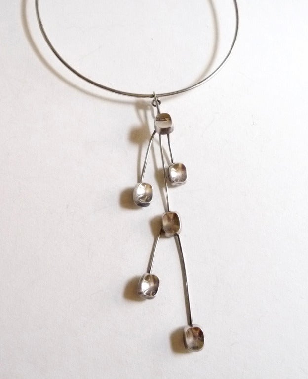 A sterling silver convertible necklace designed by Bent Knudsen of Denmark.  Necklace can be worn one of three different ways, short or long, for day or evening look.  Circumference of the choker is 15 5/16