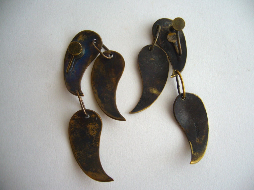 A pair of oxidized brass earrings by Arthur Smith of Brooklyn, New York.  Art Smith was an African American who opened his first shop on Cornelia Street in Greenwich Village in 1946. He is one of the leading modernist jewelers of the mid-twentieth
