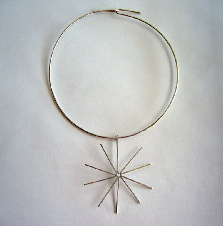 A sterling silver star necklace made by Betty Cooke of Baltimore, Maryland.  Ms. Cooke used this design throughout her career in necklaces and brooches. 

Choker has a 17 1/4
