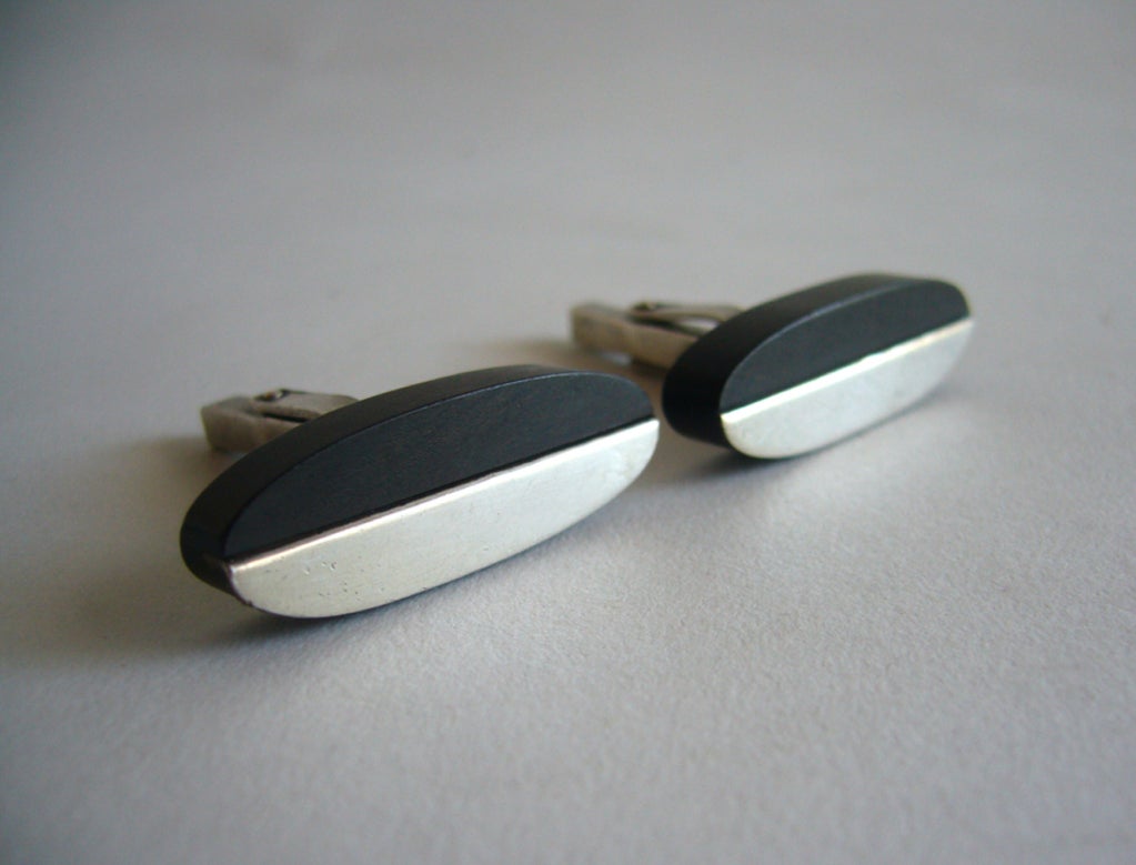 A pair of ebony and sterling silver cufflinks made by jeweler Milton Cavagnaro of San Francisco.  Cufflinks measure about 1 3/8