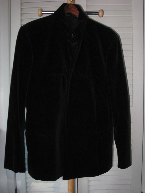 Vintage Thierry Mugler Men's Avantgarde Black Velvet Evening Suit with Snaps inside concealed instead of buttons. The high collar is closed with hooks. It has slits for all pockets, with Black Silk Lining. Pants have two silver buttons on the  back