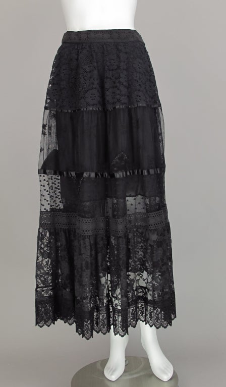Tiered black lace gypsy skirt from Giorgio Sant'Angelo early 1980s...side zipper closure...lined inside to above knee...marked size 8...Measurements are: Waist 26
