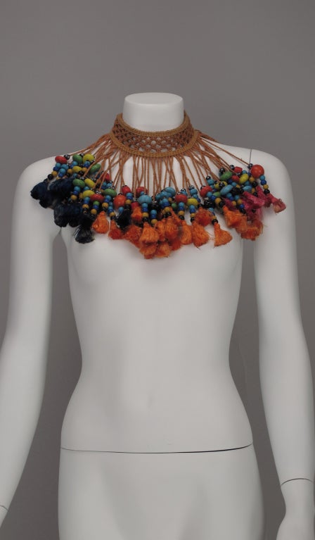 Huge corded macrame necklace/belt from the 1940s...originally a belly dancing belt...makes a stunning neck piece...loaded with coloured glass beads, tassels, and tiny brass bells...ties at back with long cords and tassels...measurements are: length