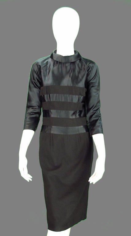 1940s black wool and silk satin dress, 3/4 length gusseted raglan sleeves, alternating insets of black wool and silk, with rolled collar neckline. The dress closes at back with a metal zipper and is Labeled Pattullo-Jo Copeland.  The Pattullo was