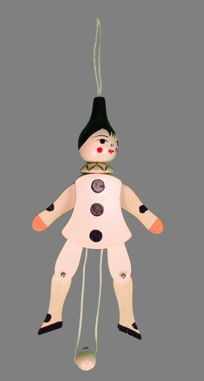 A unique Dior collectable from the late 1970s early 1980s...Pierrot was part of Dior's ad campaign & a recurring theme...this  wooden crib toy is jointed and movable with the cord and wooden ball at the base, hang from the attached cord at the