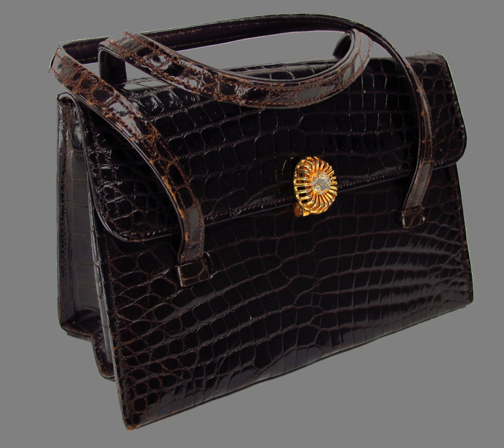 1960s classic style...dark rich glazed alligator in dark chocolate brown...Golden clasp set is with rhinestones, double strap handles...Leather lined, there is 1 zipper compartment and 2 open compartments inside...All items are inspected for