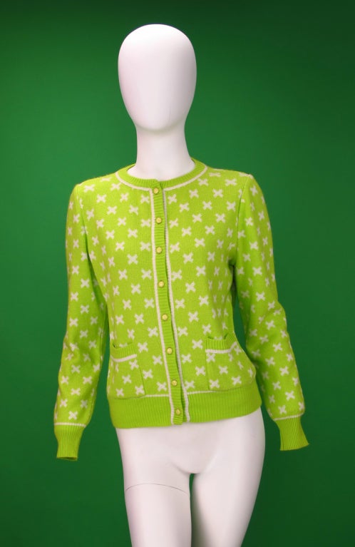 Lime green cardigan sweater with white X design, double front pockets...All our clothing is dry cleaned and inspected for condition and is ready to wear...Any condition issues will be noted...Measurements are: Bust 40